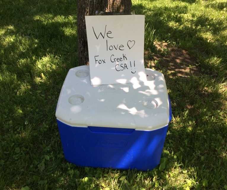 Picture of a cooler with homemade "We love Fox Creek CSA" sign